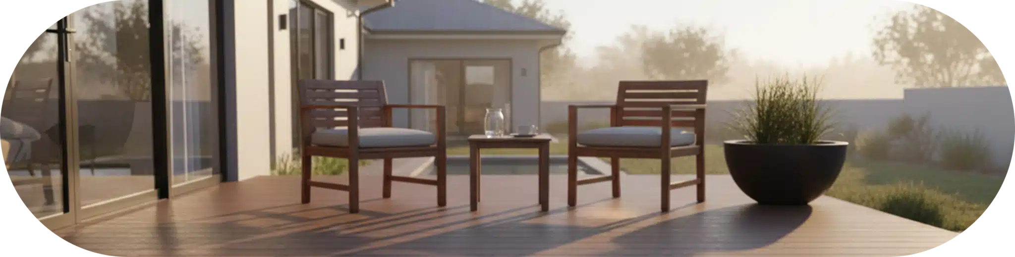Cozy outdoor patio with wooden furniture on composite decking boards, surrounded by greenery.