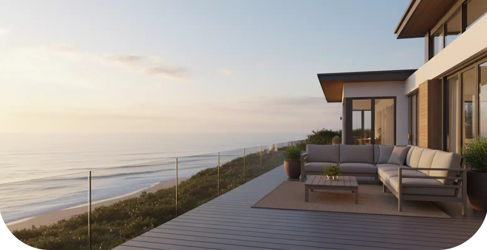 Hero image of luxury beachfront home with a composite-fascia-boards deck, outdoor seating, and panoramic ocean views.
