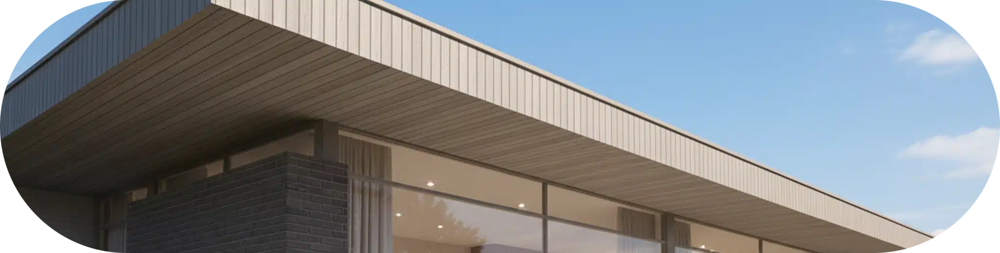 Single-story modern building with fascia boards and natural-toned siding blending with its surroundings.