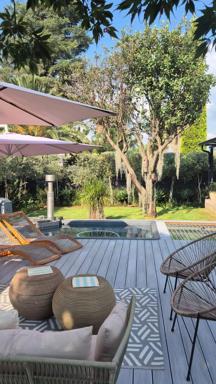Ash Grey 4 Everdeck® decking around a hot tub on the porch of a house - 2