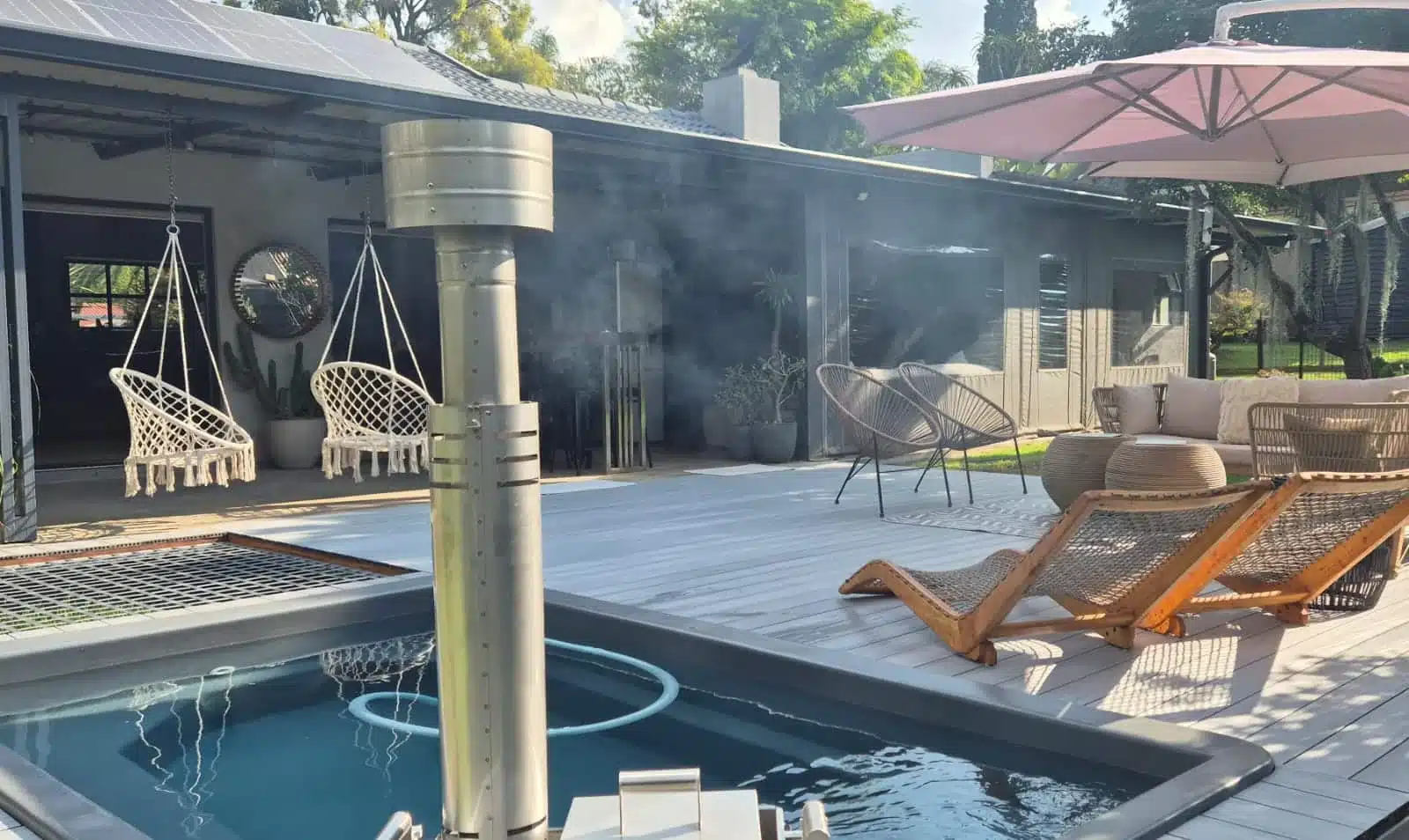 Ash Grey 4 Everdeck® decking around a hot tub on the porch of a house