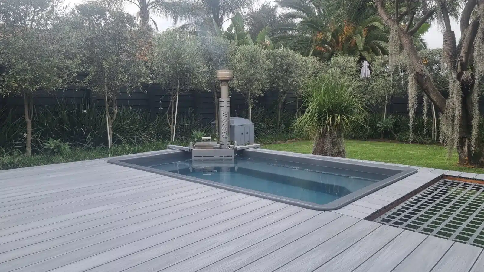 Ash Grey 4 Everdeck® decking around a hot tub in a garden